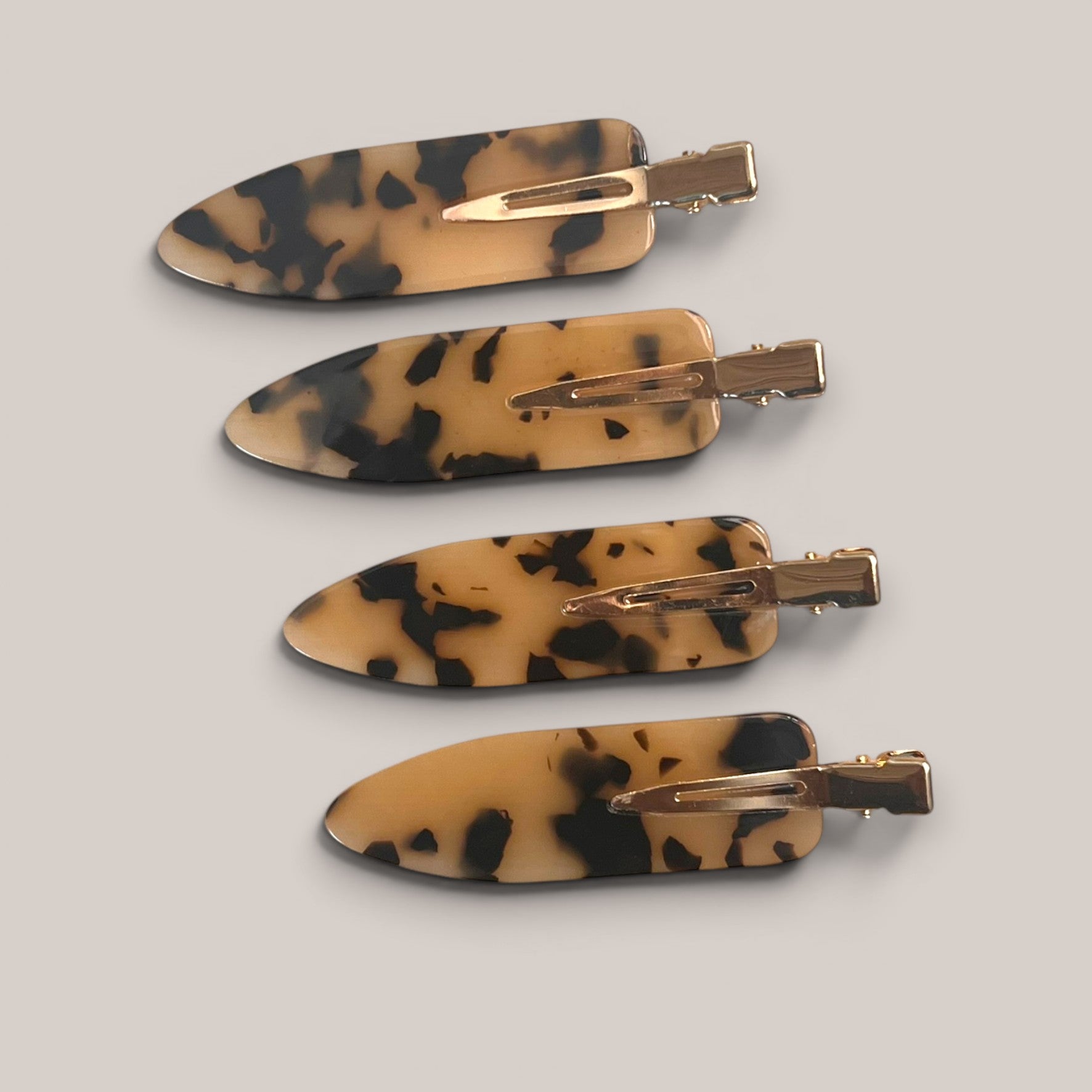 Four tortoiseshell no-crease hair clips arranged together