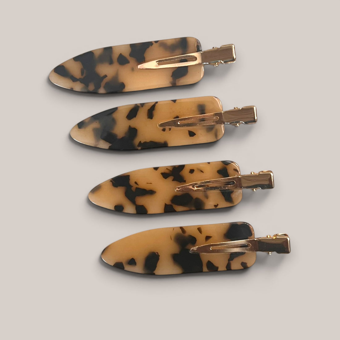 Four tortoiseshell no-crease hair clips arranged together