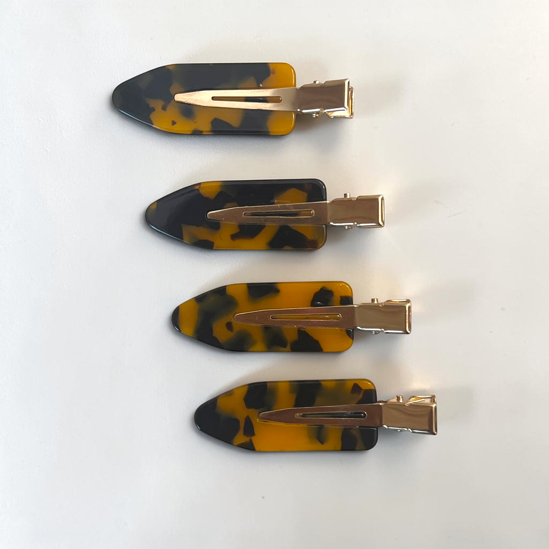 Set of four mini amber tortoise no-crease hair clips