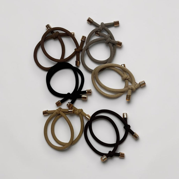 Twelve adjustable neutral hair ties in six colors with gold-tone end caps