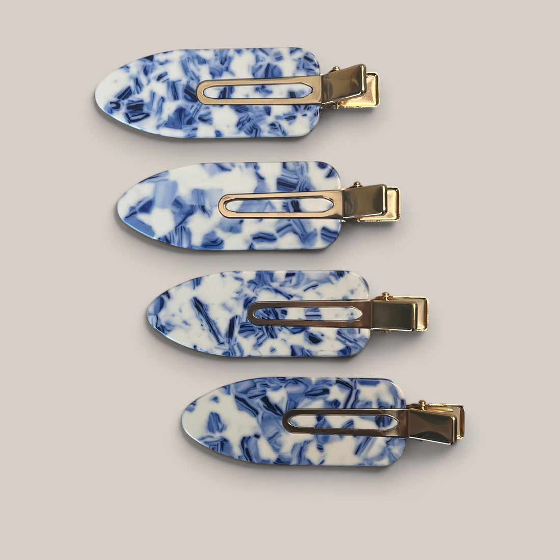 Set of four blue marble no-crease hair clips with gold-tone clasp