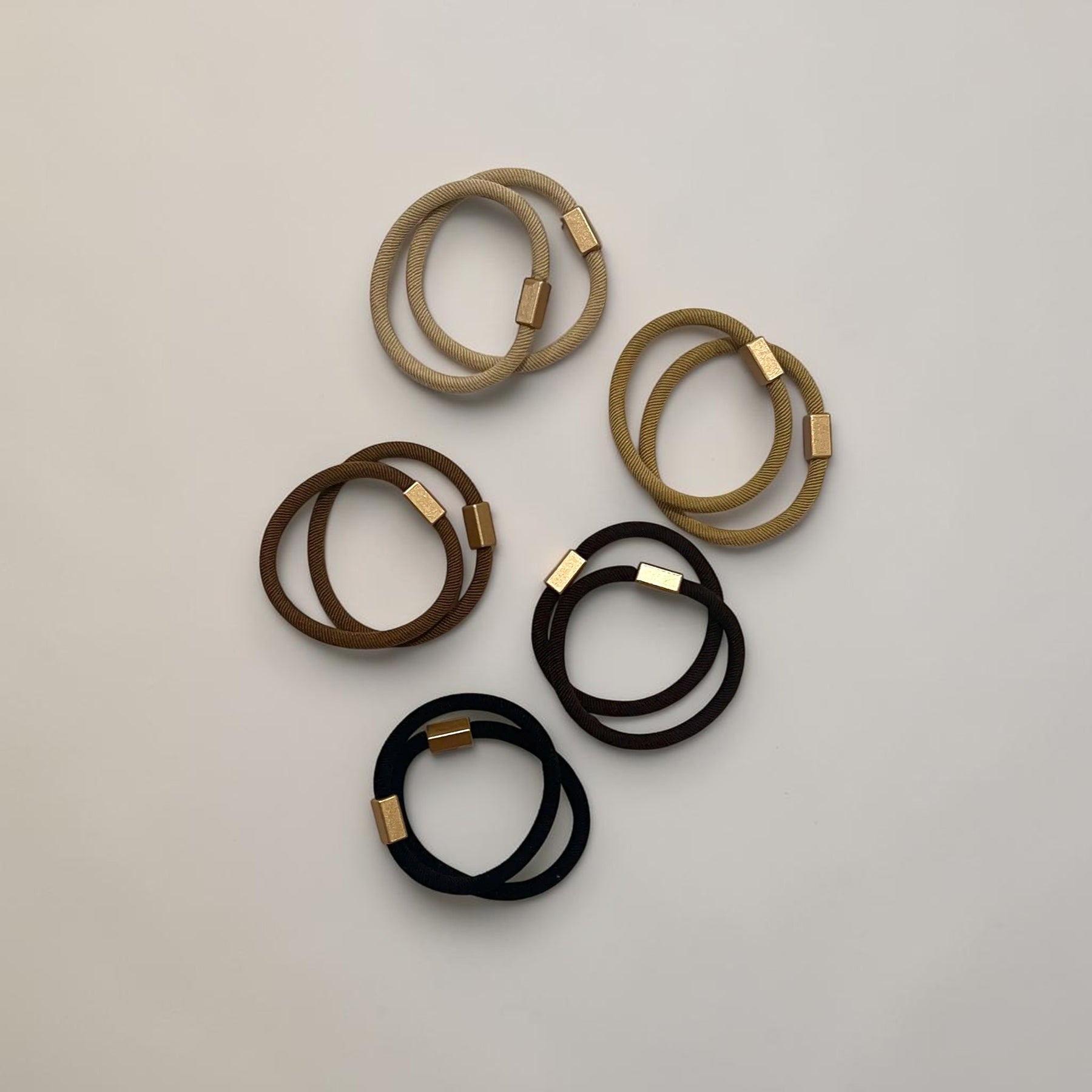 Ten neutral hair ties in five colors with gold-tone accents