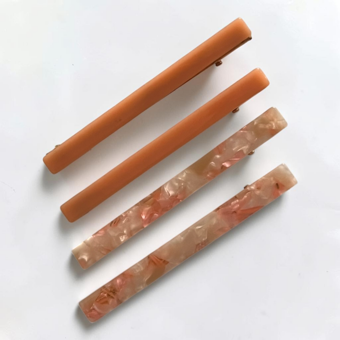 Slim acetate barrette set in peach and pink marble tones